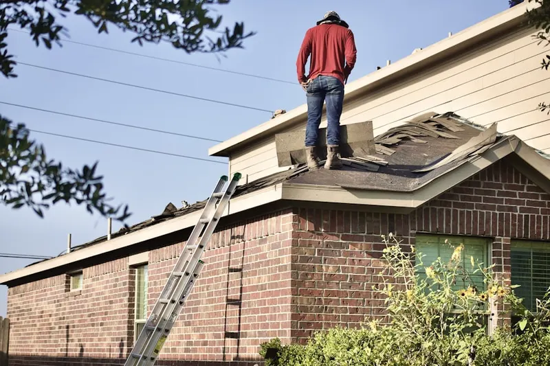 Professional roofer working on a residential roof in Featherstone